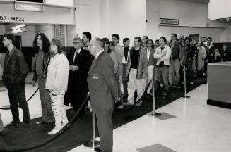 Long wait: Mourners line up yesterday at Maple Leaf Gardens to pay their last respects to sports tycoon Harold Ballard, whose body lay in state in the director's lounge