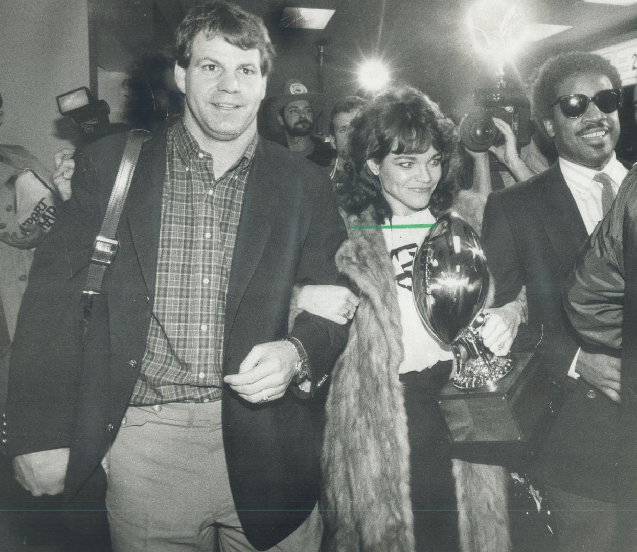 Quarterback Joe Barnes gets some help with his best offensive player trophy