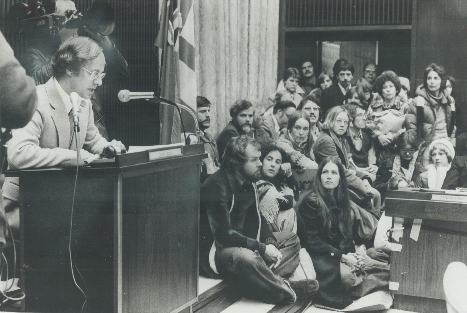 Overflow Crowd of Teachers sit on floor at Toronto school board meeting last night in Education Centre listening to Chairman Doug Barr conduct meeting(...)