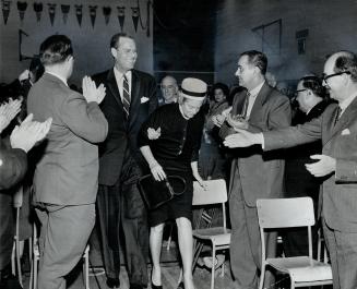 John Bassett and his wife on way to the platform