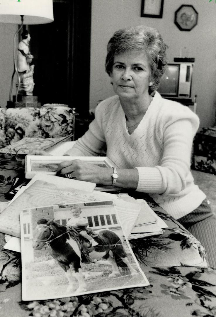 Dorothy Greenway, Dan Beckon's mother, shows a childhood photograph of her son on horseback