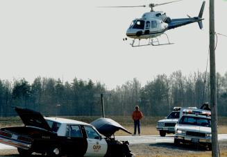 Crime spree: A police helicopter, to, hovers over an OPP cruiser yesterday in Caledon after a hijacked limousine, above left, was forced off the road