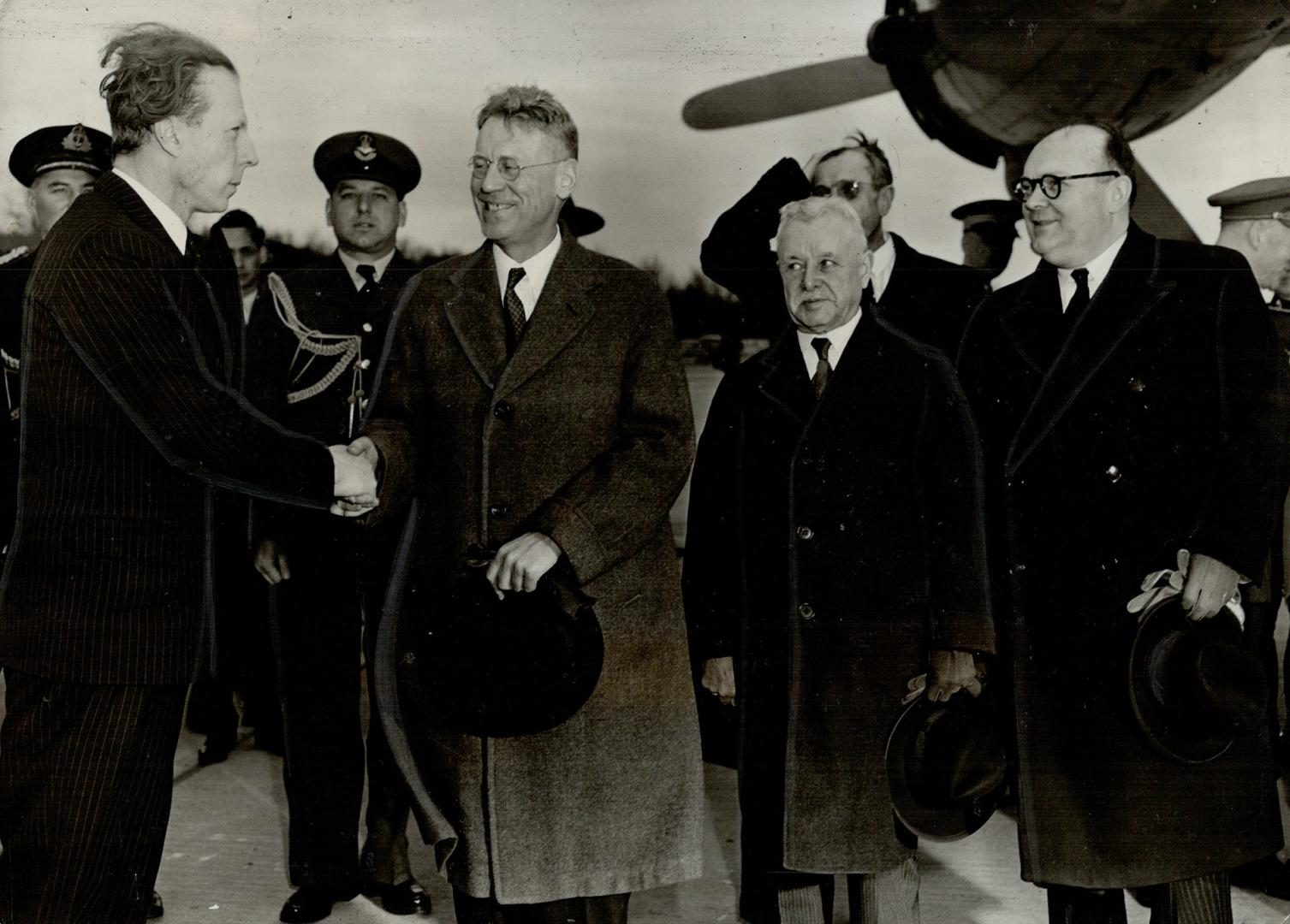 Prince Charles, Regent of Belgium, is shown here at left upon arrival at Ottawa airport yesterday where he was greeted by Rt. Hon. J. L. Isley. Prime (...)