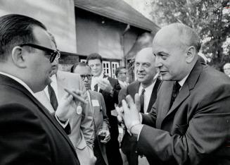 Finance Minister Edgar Benson (right) holds forth at liberal Patio party