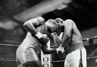 The new berbick? Former WBC heavyweight champ Trevor Berbick, right, pummels Jeff Simms of Miami last night at Varsity Arena. Berbick, who was anythin(...)