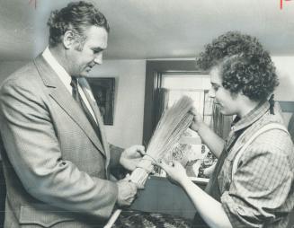 A new broom in an old style. Leo Bernier, minister of natural resources, studies the handiwork of John Adams, 18, in the broommaker's shop at Black Cr(...)