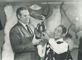 Soapstone carving is presented to Leo Bernier, Ontario minister of natural resources, by sculptor Seeana Attagutak, 38, of the Eskimo settlement of Po(...)