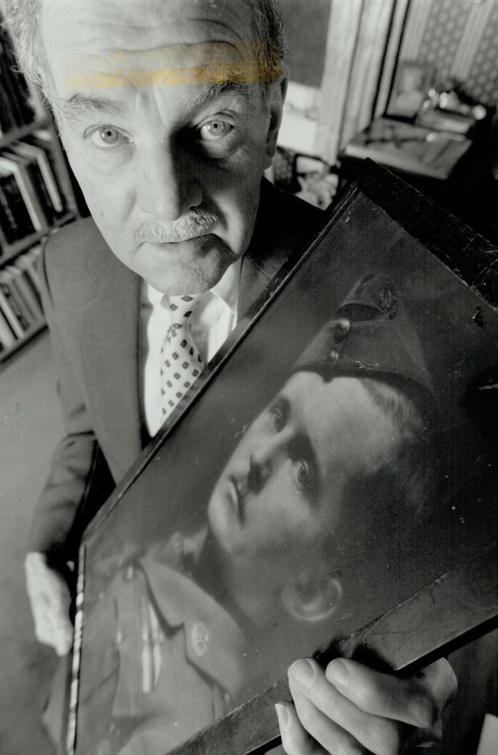 World War II veteran and author Arthur Bishop holds a photograph, above, of his father, Billy Bishop, the World War I flying ace. Right, the senior Bishop pins RCAF pilot wings on his son in 1942