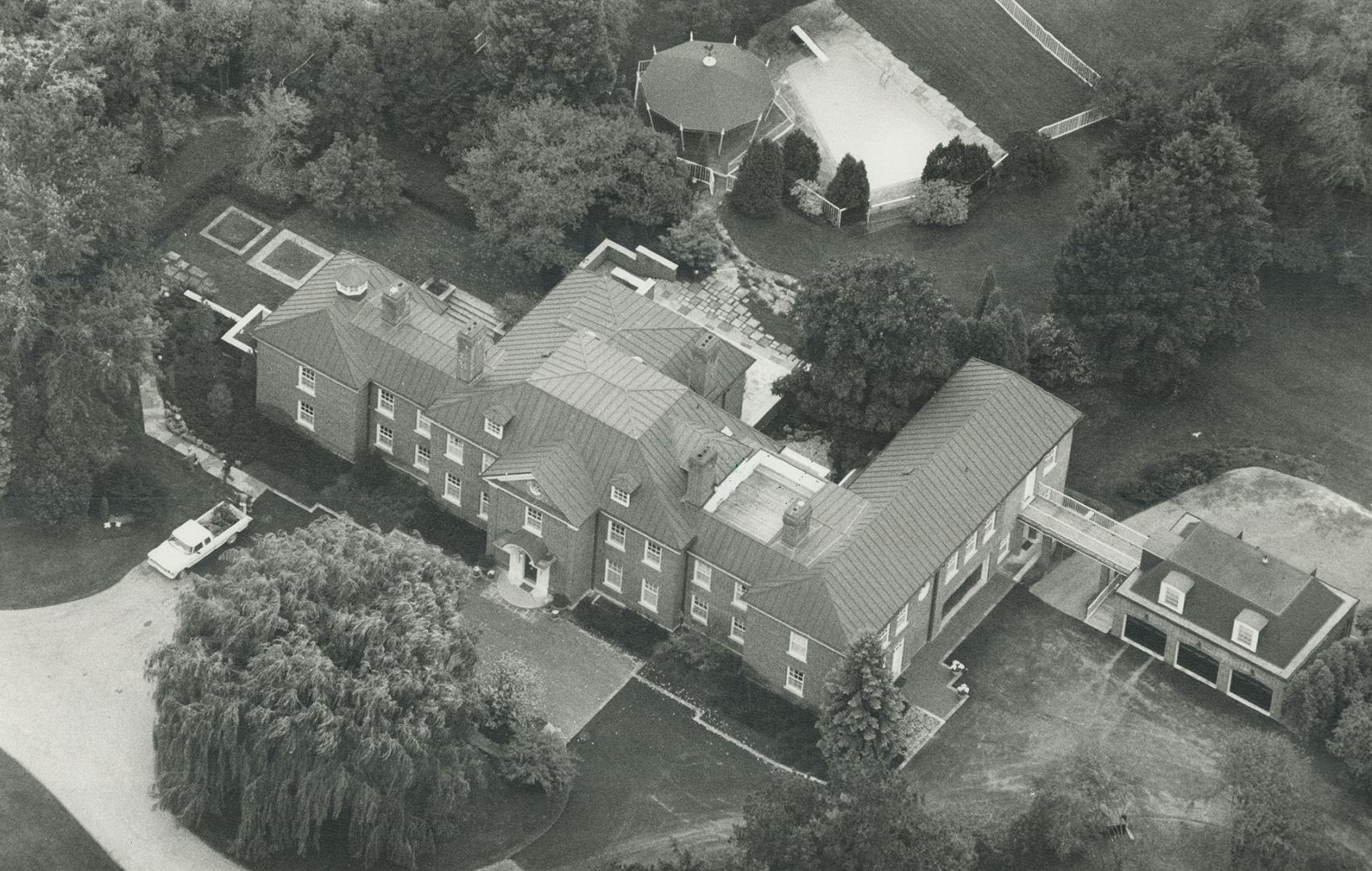 Man of means: Conrad Black enjoys the $3 million house he built in Toronto (above) and has passion for cars