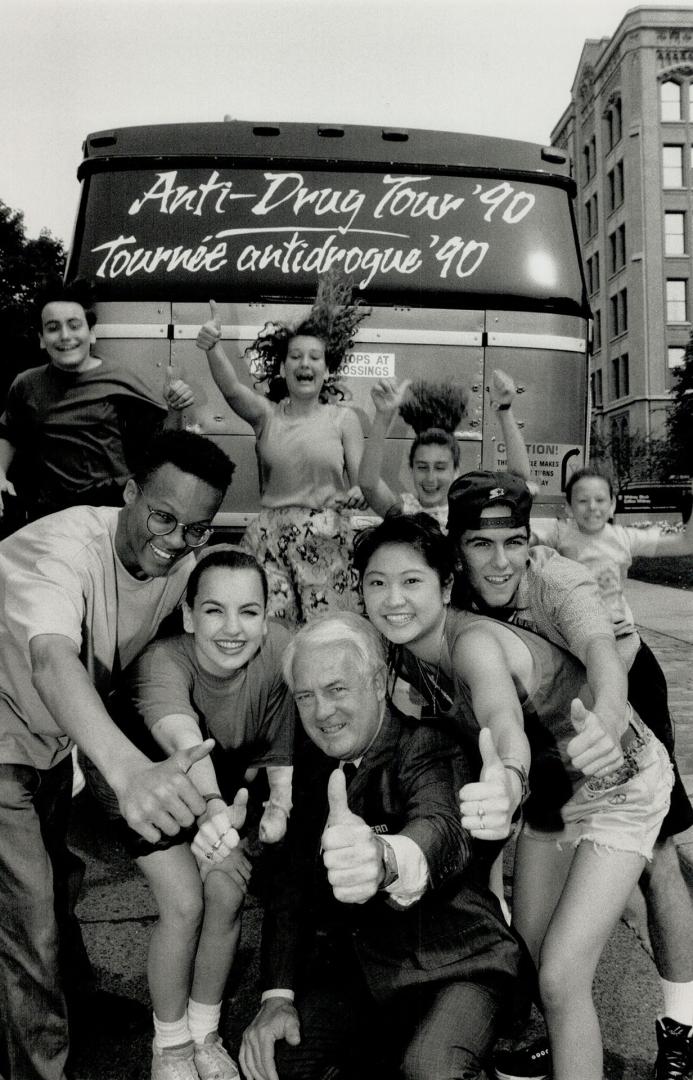 Good sign: Tourism Minister Ken Black and some Stage Kids says thumbs up at Queen's Park yesterday before the troupe takes its anti-drugs message on the road