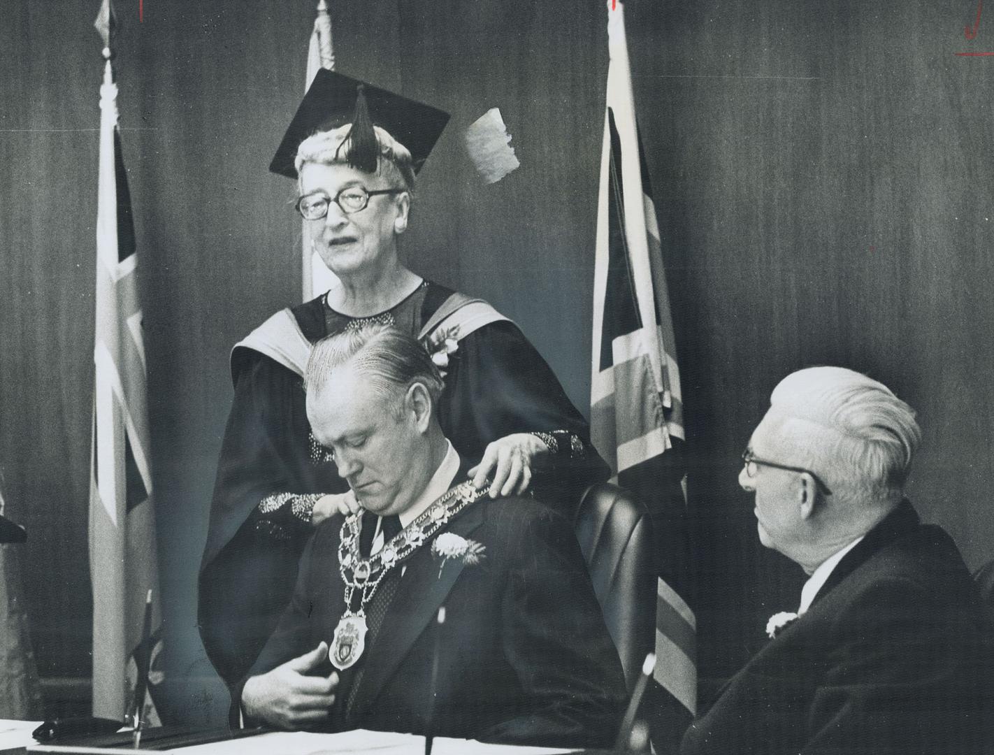 East York Mayor Willis Blair receives his chain of office from True Davidson, his predecessor, who has retired after 24 years in politics. Blair repeated pledge to work to preserve neighborhoods