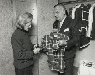 The Blass menagerie: U.S. designer Blass shows one of his snappy spring suits to a Holt Renfrew customer