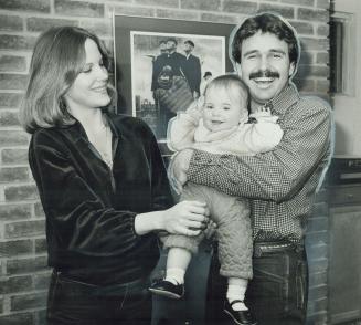 Proud parents: Rick Bosetti of Blue Jays and his wife, Patti, proudly show off their young daughter, Alycia, eight months