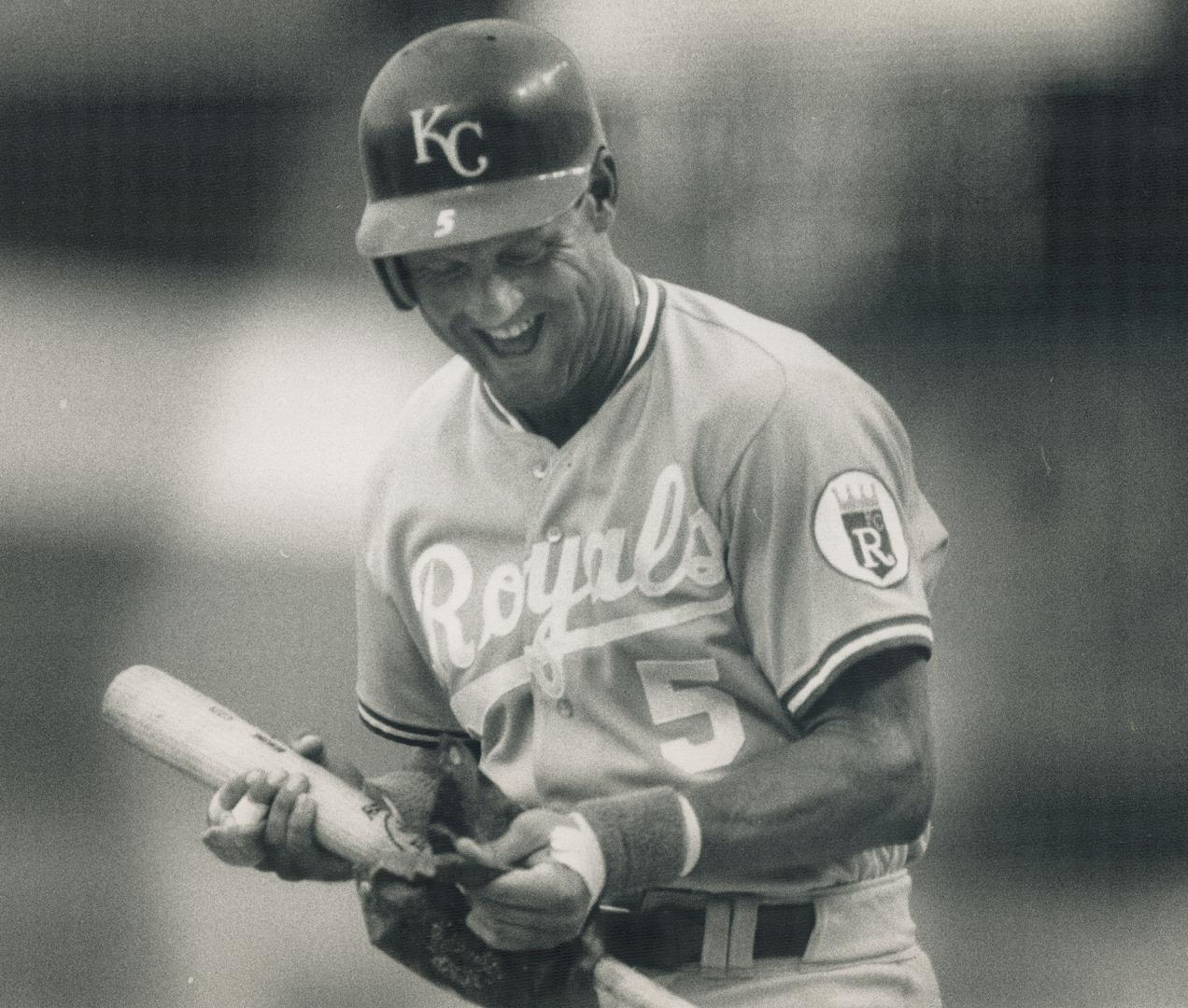 They caught George: First baseman George Brett of the Kansas City Royals smiles despite being caught with too much pine tar on his bat in the first inning by plate umpire Jim Evans