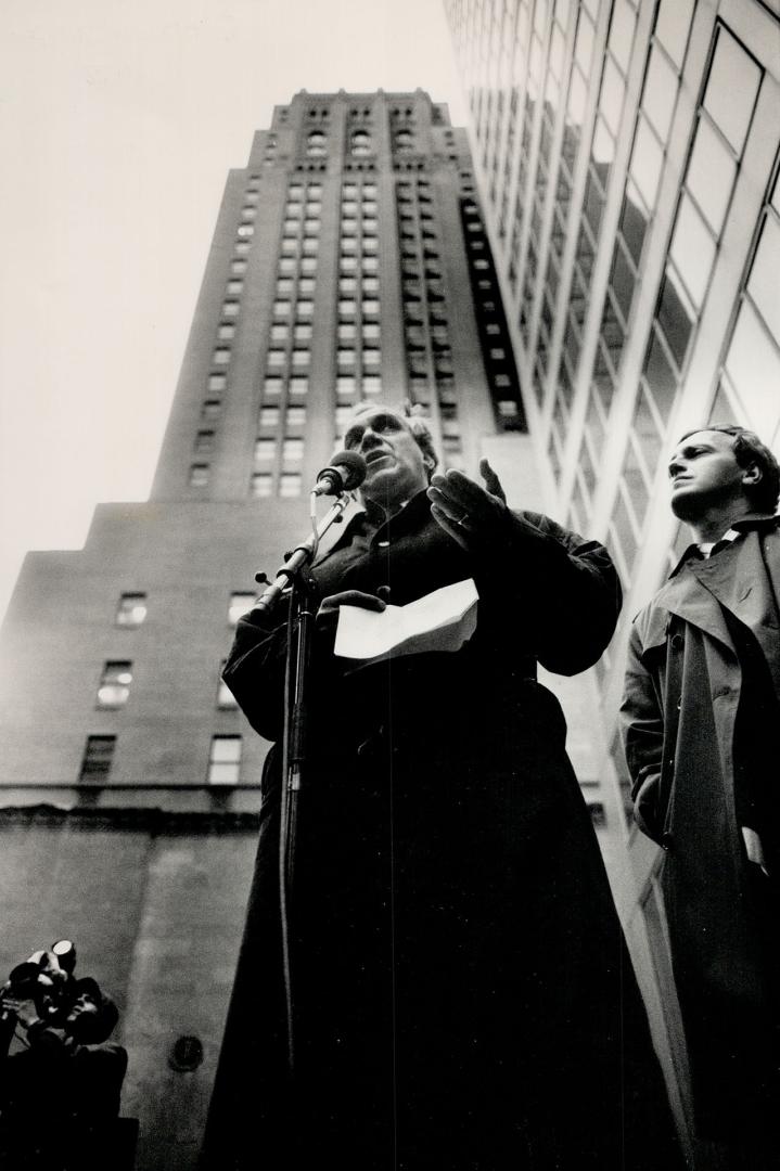 Scene setter. New Democratic Party leader Ed Broadbent ignores drizzleand strong winds at Commerce Court in Toronto as he denounces the values of Wall St. and Bay St