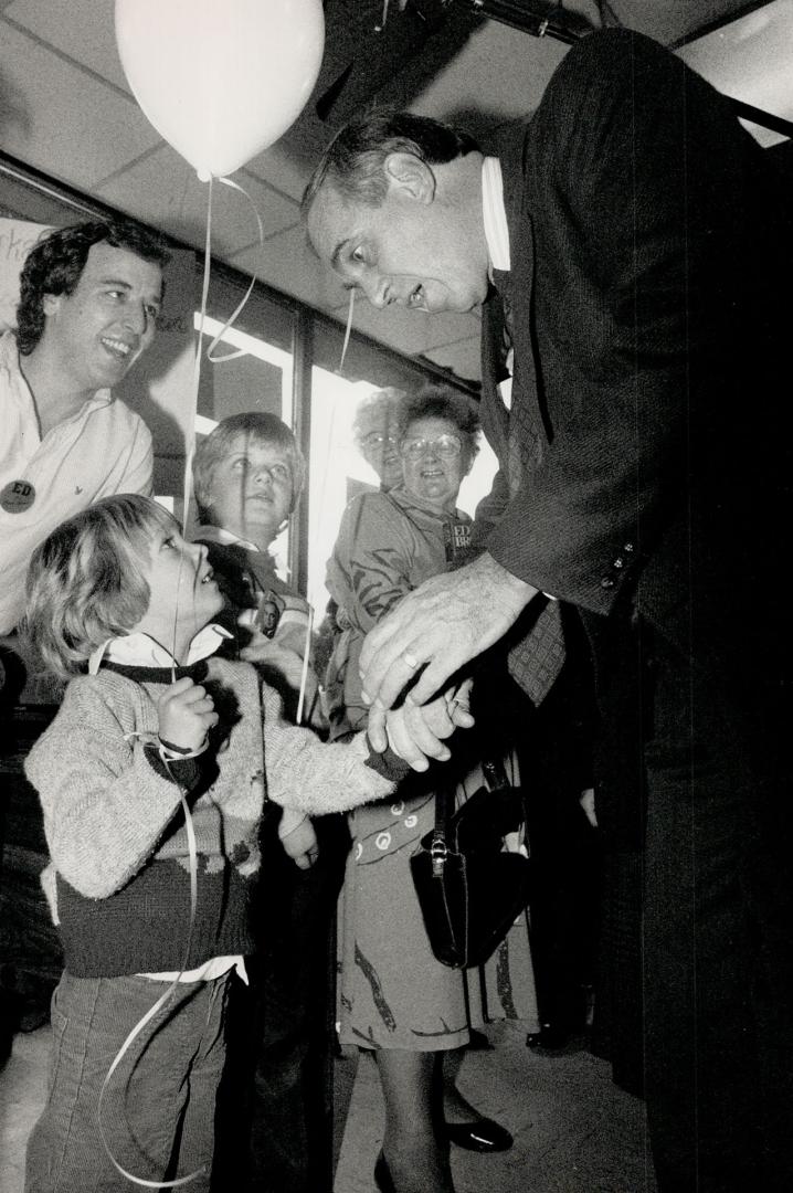 Above, he campaigns at local party headquarters in Oshawa