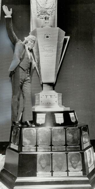 Super cup: Blue Bombers' quarterback Dieter Brock, Schenley Award winner for second straight year, climbs aboard giant-sized replica of trophy at awards ceremonies in Montreal