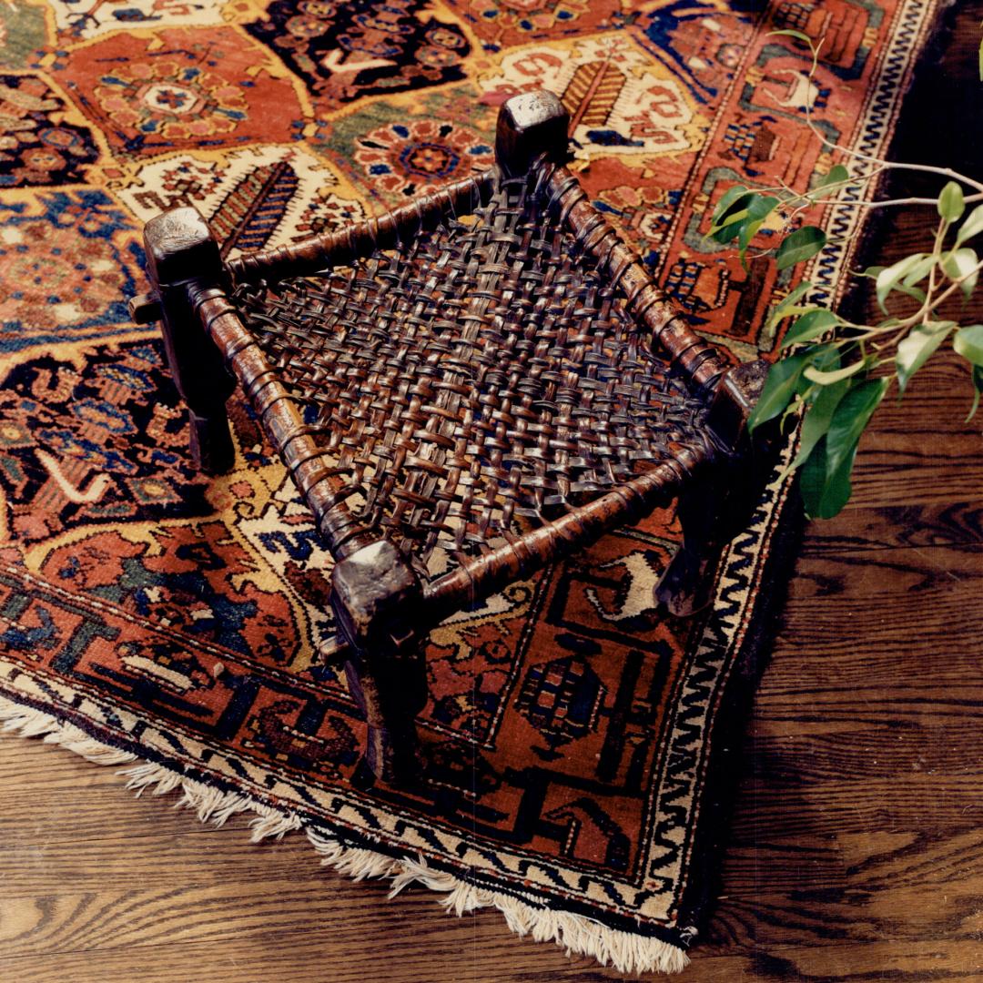 Above, Hilary Brown considers this primitive footstool, presented to her by a woodcutter in 1973, her greatest prize