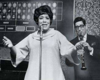 Olive Brown belts out a number in the manner that won her title of Empress of the Blues, accompanied by Henry Cuesta on clarinet, at the Golden Nugget last night