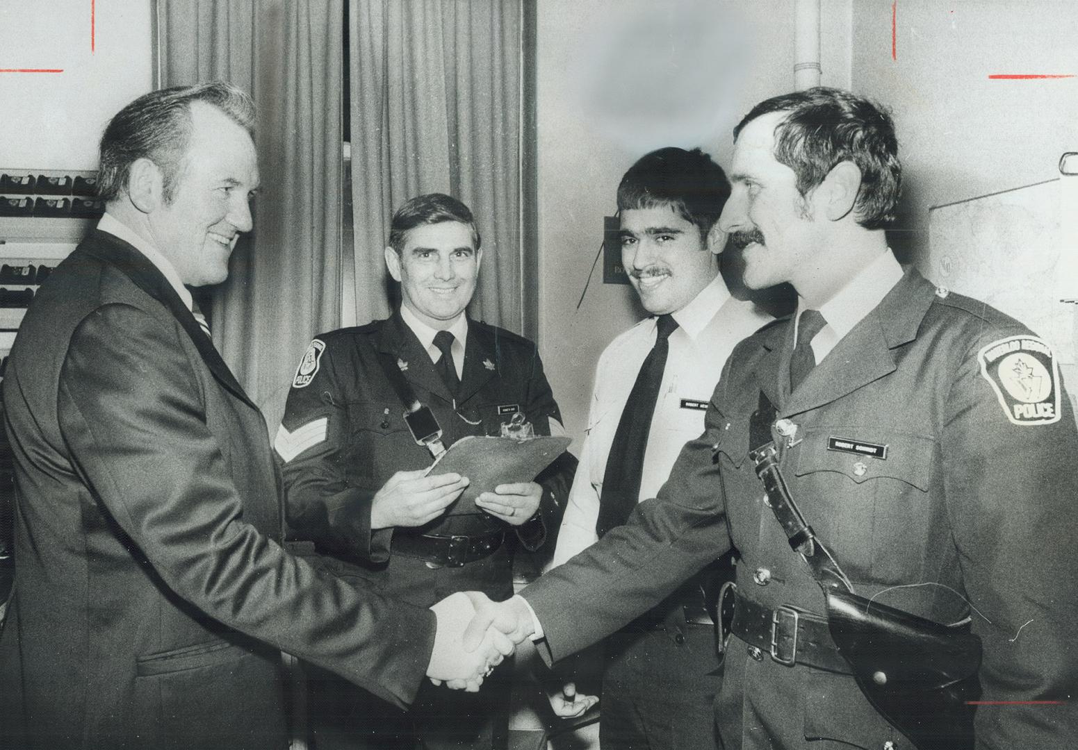 Shaking hands with some of his new staff is newly appointed police chief of Waterloo Regional Police Force, 51-year-old Syd Brown, left. For 15 years,(...)