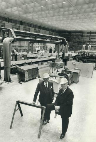 U.S.S. Enterprise? No, it's the beginnings of the new trading floor of the TSE. Exchange president J. Pearce Bunting shows off model at left and above(...)