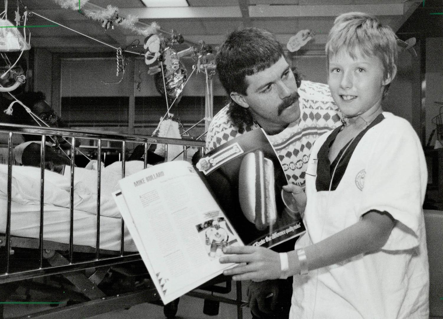 A hero's welcome: Krishton, left, and Matthew welcome their hockey heroes Mike Bullard and Dave Ellett, right, as the Leafs paid visit to Sick Kids hospital