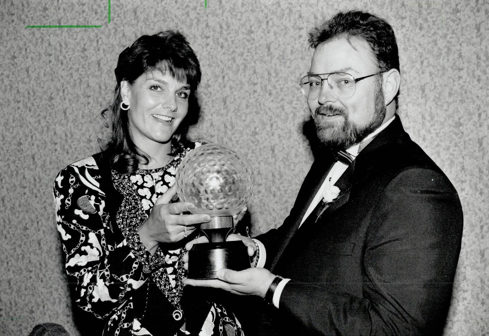 Nice welcome home gift: Burlington's Barb Bunkowsky accepts her first Score Magazine award as Canada's top female golfer yesterday from Bob Donnelly