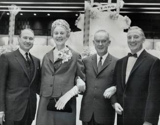 G. Allan Burton, Diana Pidduck, Edgar G. Burton and C. J. Dunn, chairman. A huge dummy cake fell away to reveal the car presented to Miss Pidduck