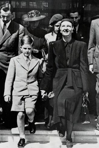 Ex-king Simeon, nine, of Bulgaria, grandson of the dethroned Victor Emmanuel of Italy, holds hand of Queen Mother Giovanna at Istanbul, Turkey, en route to Egypt