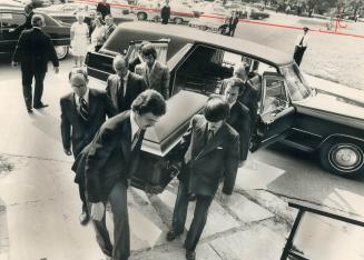 Members of his family carry the body of Albert Campbell into St