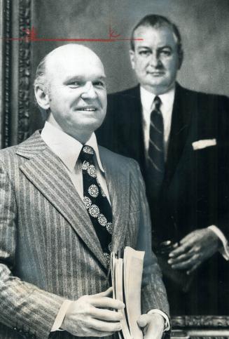 Donald G. Campbell, 51, president and chief executive officer of Maclean-Hunter Ltd., stands beside portrait of Donald F. Hunter, 65, chairman, in the(...)