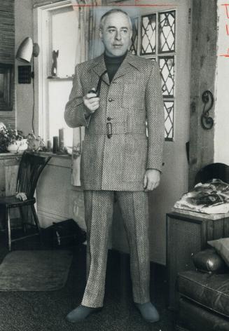 Dr. Daniel Cappon, psychiatrist who teaches at York University, wears Irish tweed country suit in moss green styled with flared pants and belted jacke(...)