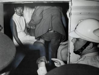 Looking tired and dismayed, writer-broadcaster June Callwood sits silently in a paddy wagon after being arrested in Toronto's Yorkville districk last (...)