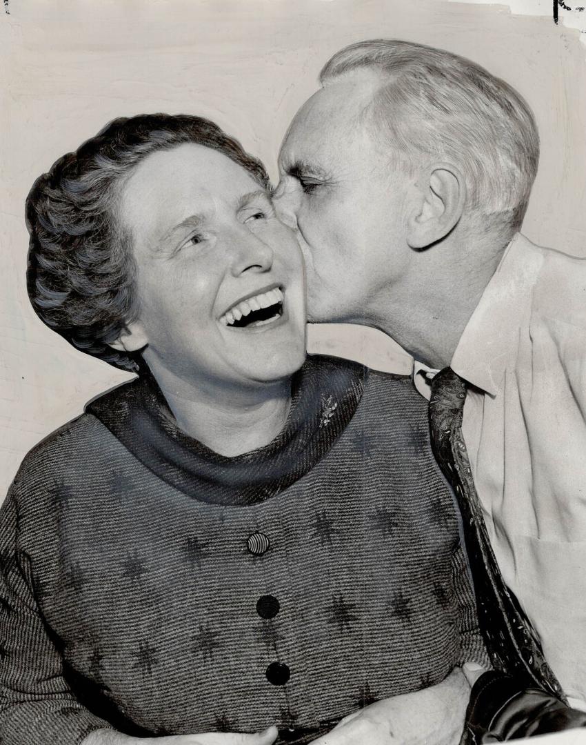 New Alderman for Ward Two, Mrs. Margaret Campbell gets victory kiss from husband. Other half of Ward Two team is Ald. May Birchard. It is first time t(...)