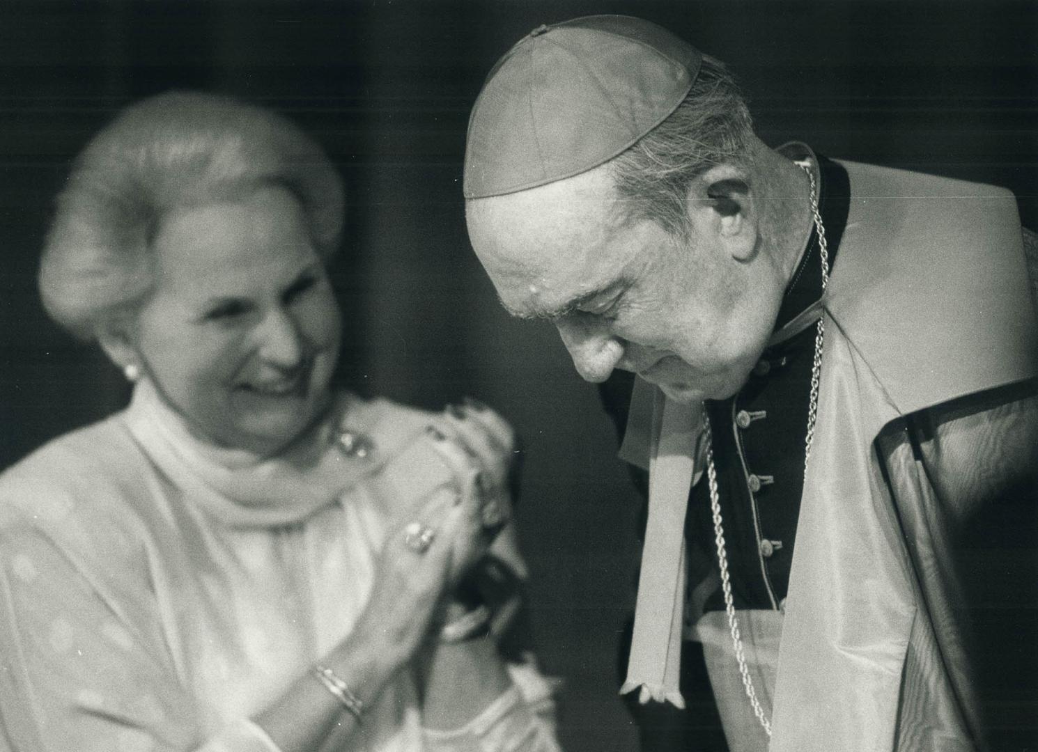 Three milestones: G. Emmett Cardinal Carter acknowledges a standing ovation by 3,000 at a testimonial dinner as Governor-General Jeanne Sauve joins in(...)