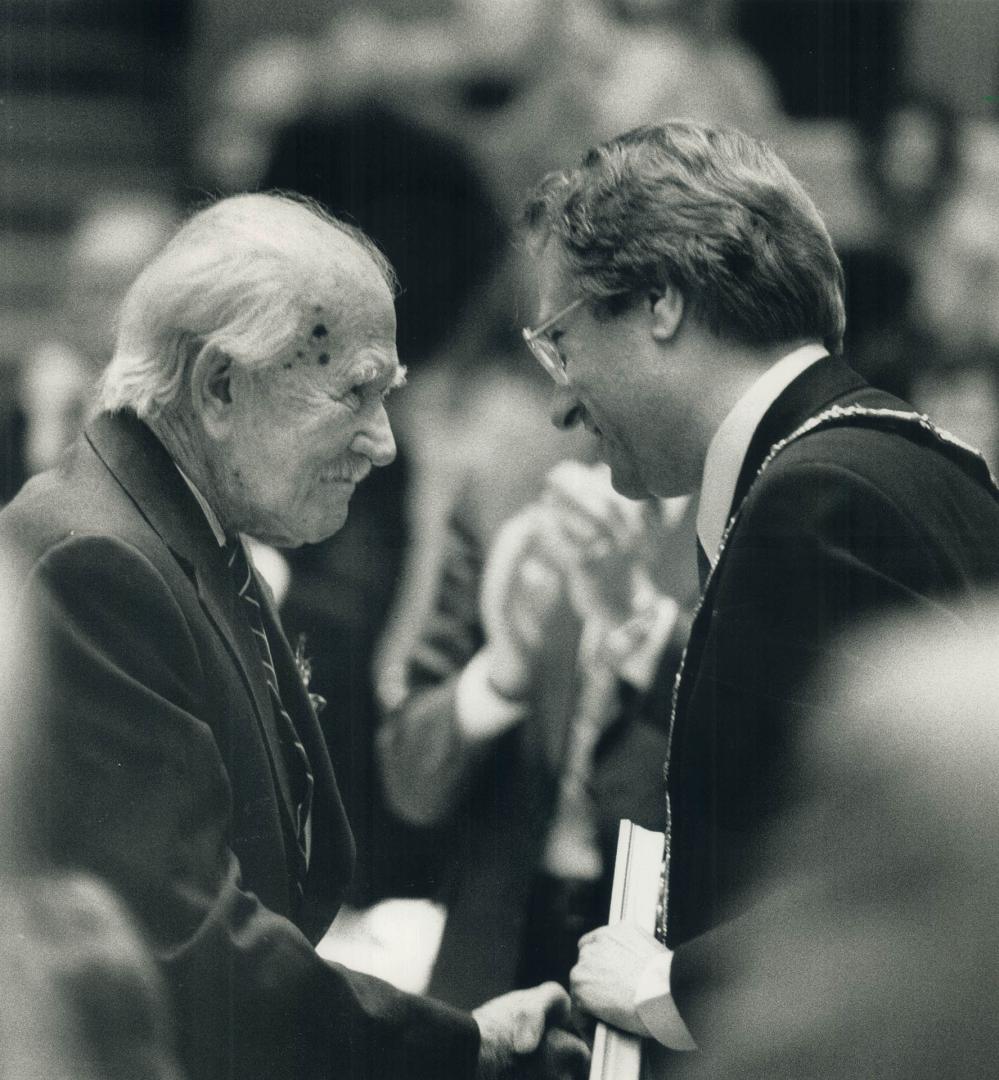 Artist A. J. Casson, left, is greeted with a standing ovation yesterday as Mayor Art Eggleton presents him with Toronto's special commendation. Casson(...)