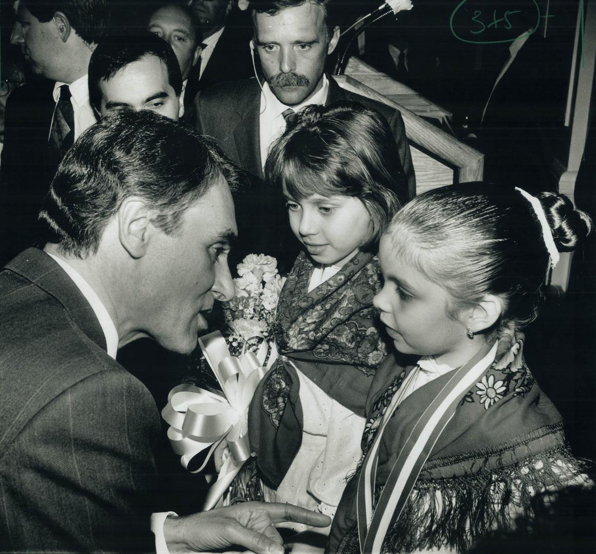 Proud Moment: Tania Fegundes, 8, centre, and Rebecca Pereira, 6, welcome Portuguese Prime Minister Anibal Cavaco Silva last night at a reception