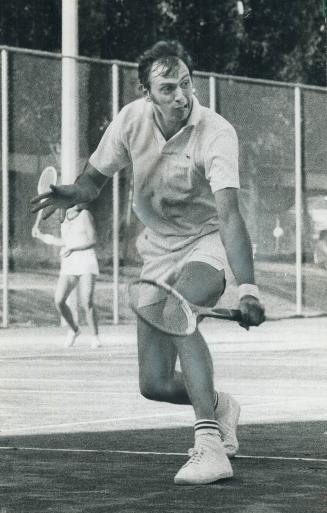 Grim determination shows on face of Keith Carpenter of Toronto Lawn as he backhands return to Brian Mitchell on his way to victory yesterday in invita(...)