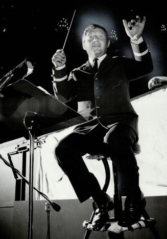 In captain's uniform, Berthold Carriere, 40, conducts the orchestra for HMS Pinafore, Music director of the Stanford Festival, he is composing music for two other productions