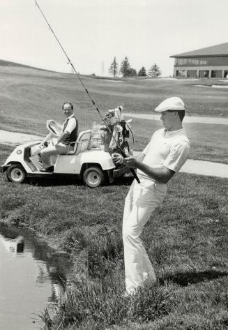 George Bell (left) blasts out of sand during the Ernie Whitt Charity Classic yesterday at Nobleton Lakes