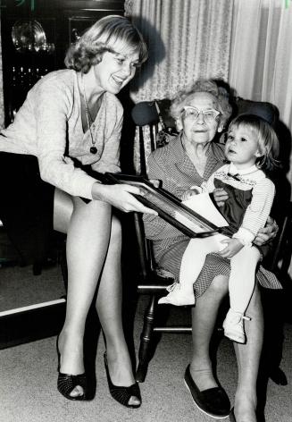 Scroll of honor: York Mayor Gayle Christie presents Lily Stearne (holding great-granddaughter Ashley Ricci, 18 months) with a scroll honoring her on her 100th birthday