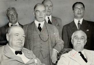 Battle problems of the Pacific fronts were discussed at a war council meeting in Washington, attended by Prime Minister King. He is shown here with Winston Chruchill and President Roosevelt