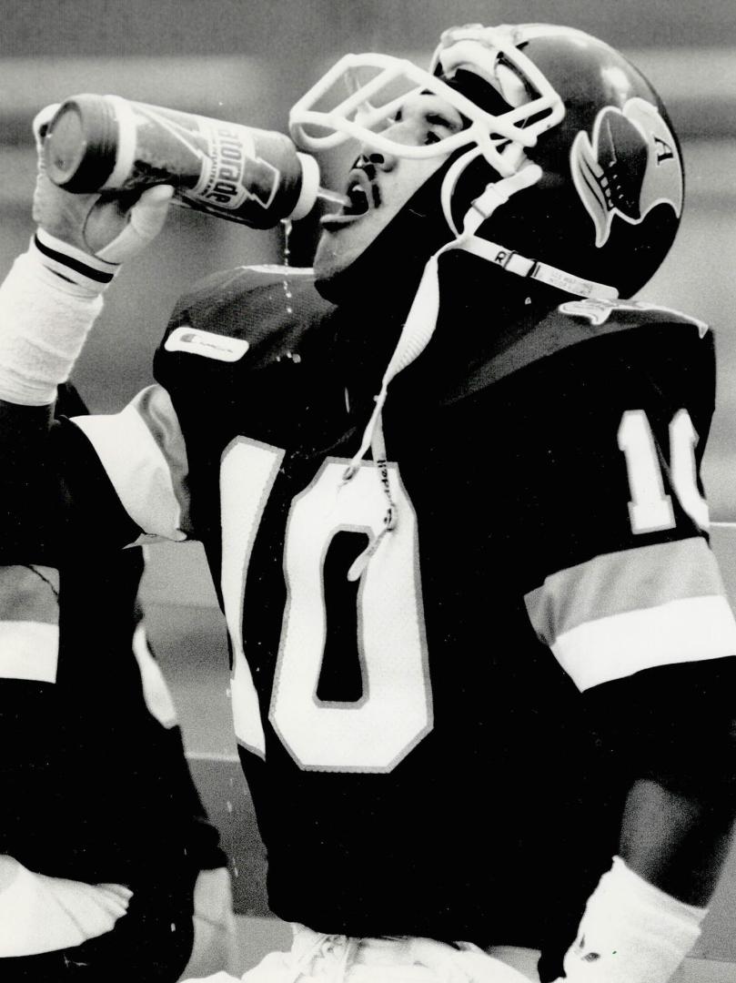 Break time: Clash takes time out for a little bit of refreshment on the sidelines during yesterday's Eastern Division matchup against the Winnipeg Blue Bombers at Exhibition Stadium