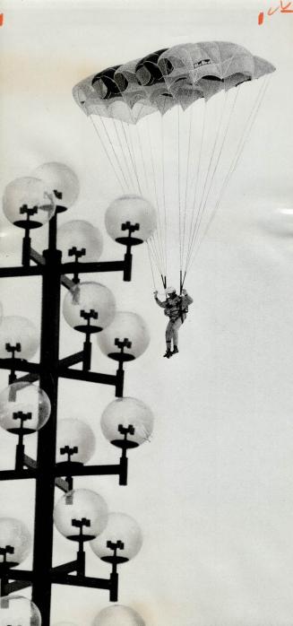 Skydiver Bill Cole floats to earth at the Scarborough Civic Centre, scene of the mayor's Red Cross blood donor clinic yesterday, the Scarborough flag (...)