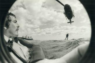 Cooper waits in Lake Ontario as helicopter lowers diver