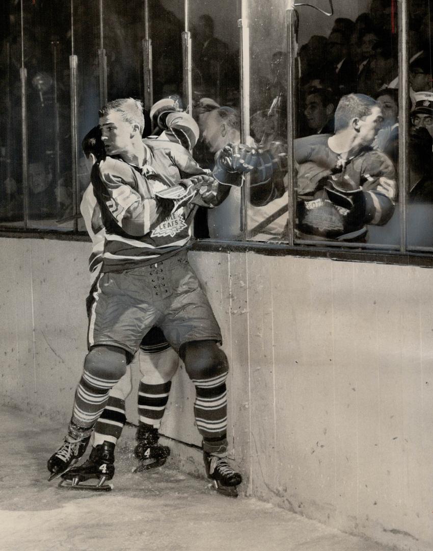 Conacher and his image. Reflection in glass as Arnie Brown boards him