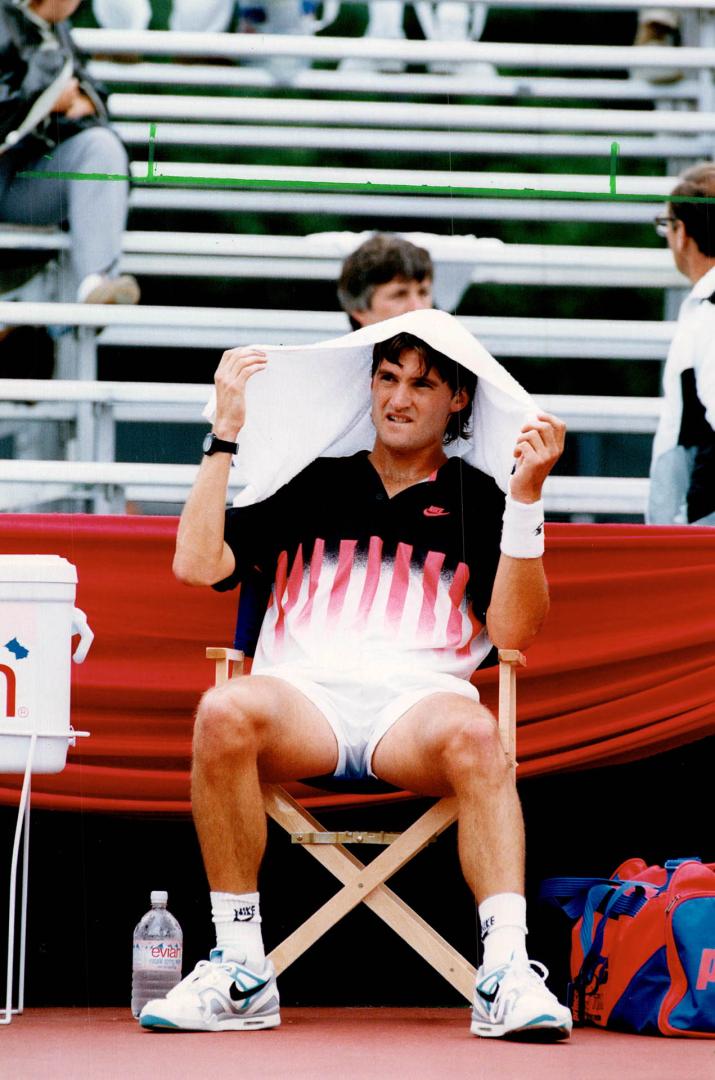 Shelter from the storm. Grant Connell takes cover at the Sun Life Nationals. Connell Ied Brian Gyetko when the men's final was suspended by rain in the third set