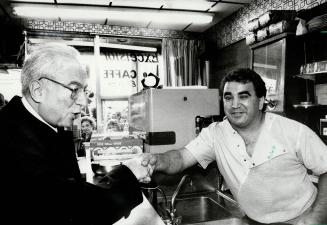 Image shows the President shaking hands with an employee at the coffee shop.