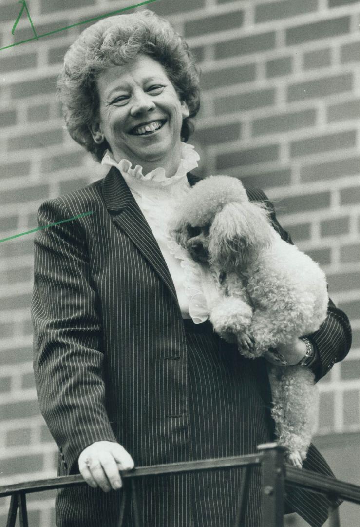 Relaxed: Scarborough Alderman Florence Cruickshank cuddles her toy poodle Beau during a moment of relaxation at her Alpaca Dr. home. A provincial cabinet minister calls her the consumate politician