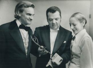 Twenty years with the National Ballet, conductor George Crum (centre) last night was honored for his service with presentation of a Celia, a bronze sc(...)